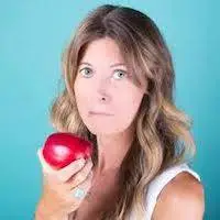 Kelly Costigan holding an apple